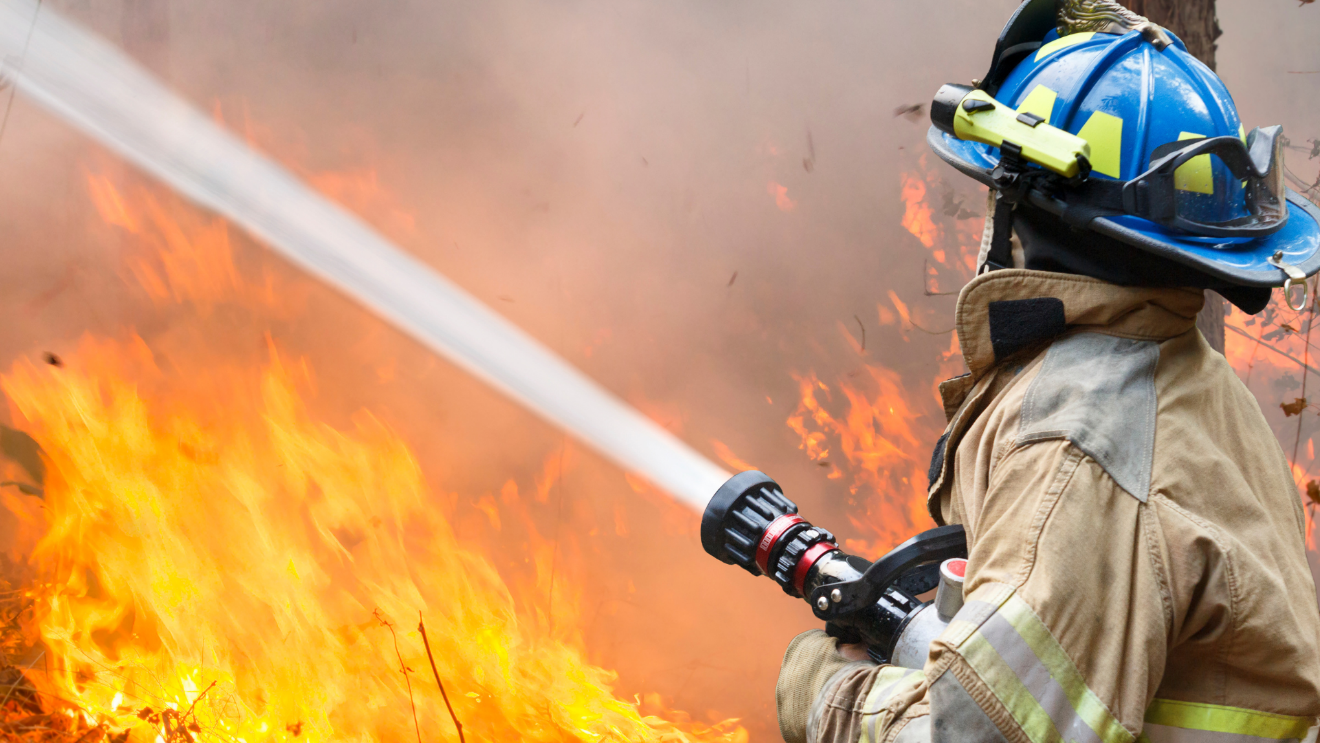 A firefighter spraying a fireAI-generated content may be incorrect.