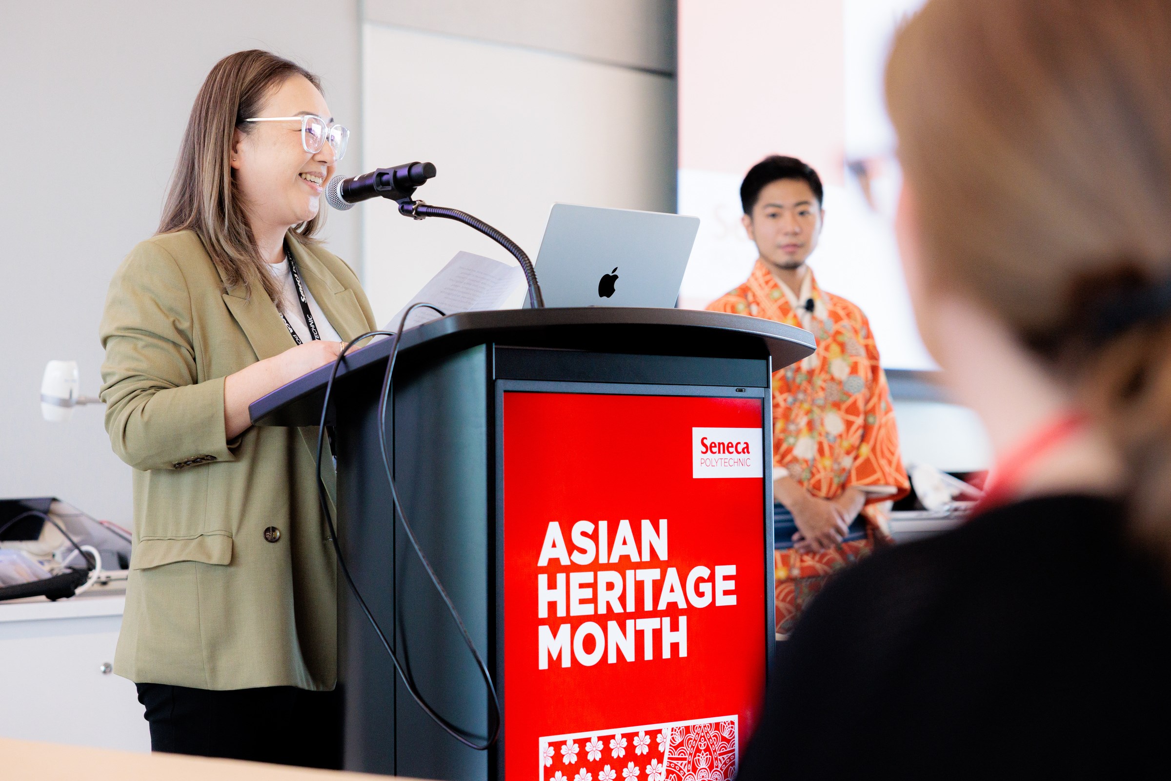 Rei Tang at the podium introducing the workshop host, Shuichi.