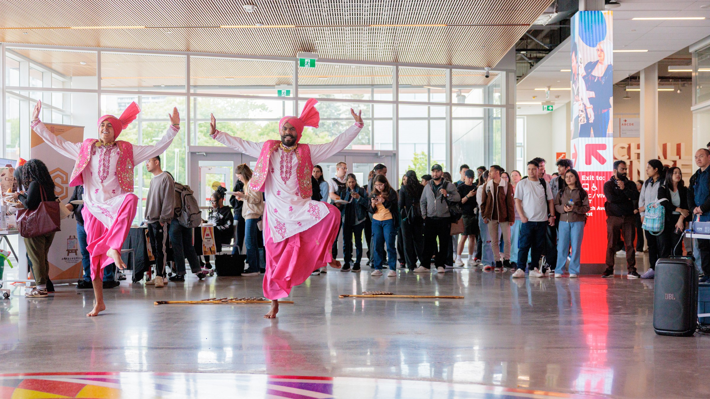 Bollywood dancers performing around a group of students