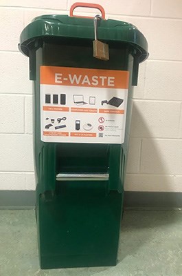 green e-waste bin with an orange e-waste signage